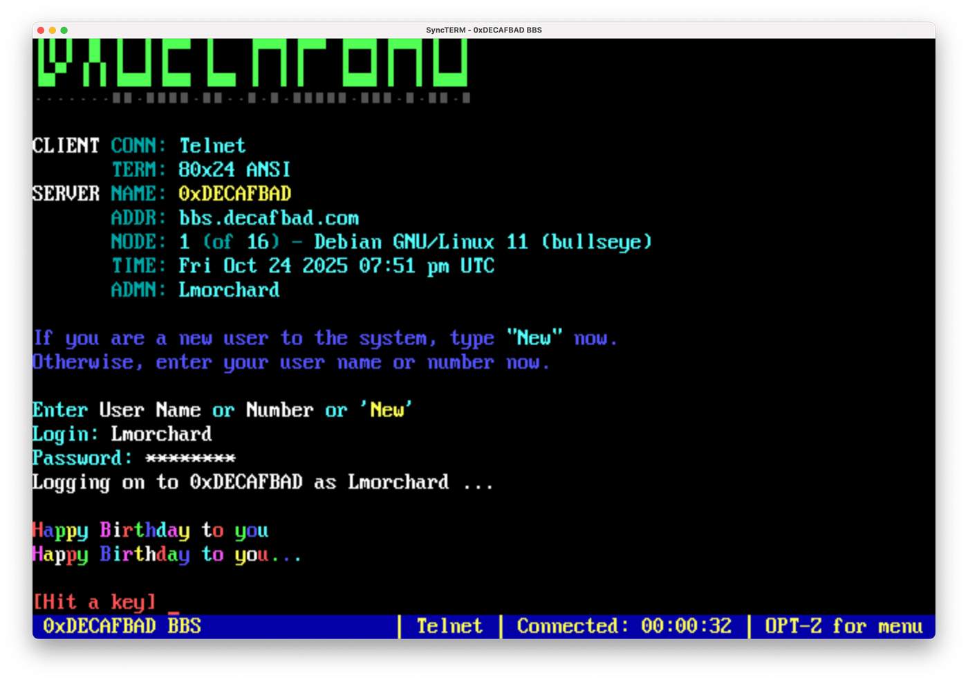 Screenshot of 0xDECAFBAD BBS login displaying colorful Happy Birthday messages in rainbow text on a black terminal screen