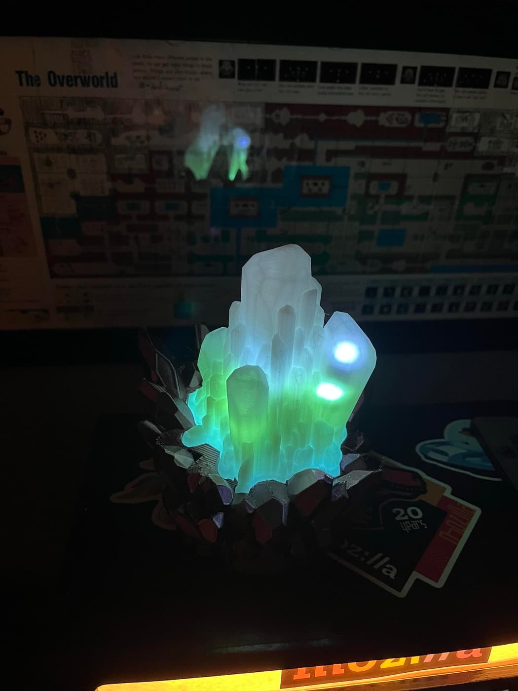 The same crystal glowing green and blue under blacklight