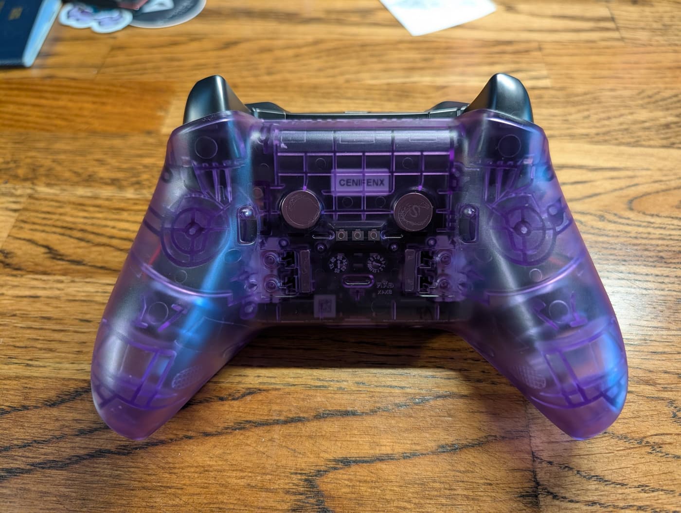 Photo of the underside of an Xbox Elite 2 game controller, now in a shell of translucent purple plastic showing the innards