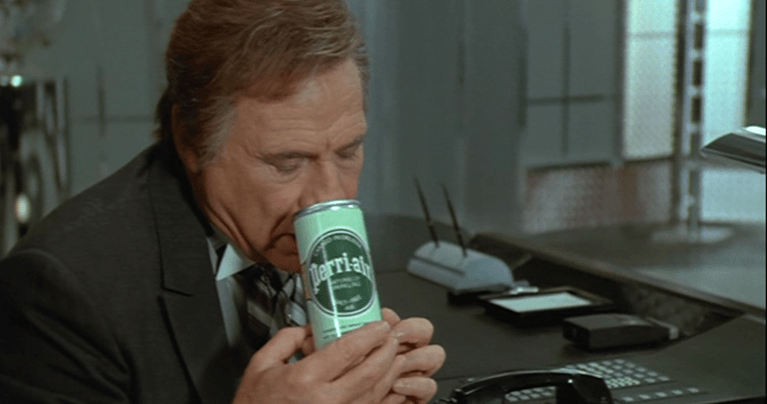 A framegrab from Spaceballs (1987), showing President Skroob (Mel Brooks) breathing a can of Perri-Air.