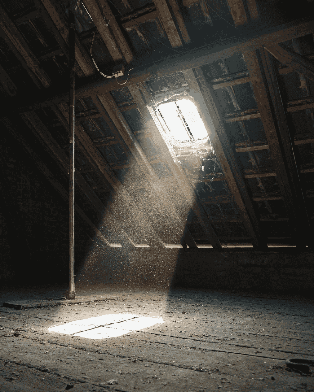 Sun rays streaming into a dusty wooden attic